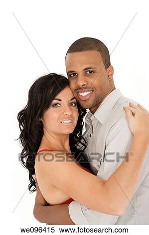 Stock Photography - Interracial couple sharing and intimate moment. Fotosearch