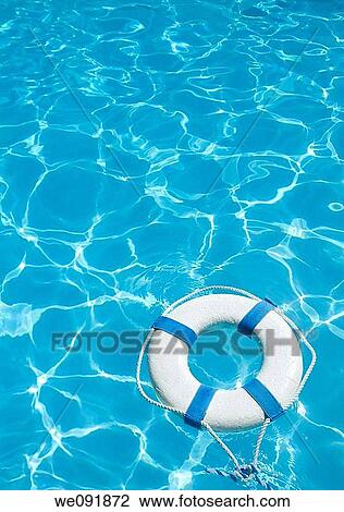 Life ring floating on top of sunny blue water View Large Photo Image Stock Image - Life ring floating on top of sunny blue water. Fotosearch