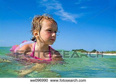 Stock Image - Little blond girl swimming in the tropical water at Cayo Jutias, Cuba. Fotosearch