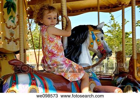 Little girl riding the horse of a merry go round View Large Photo Image Stock Image - Little girl riding the horse of a merry go round. Fotosearch