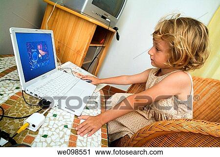 Little girl using a white Apple Ibook laptop computer View Large Photo Image Stock Image - Little girl using a white Apple Ibook laptop computer. Fotosearch