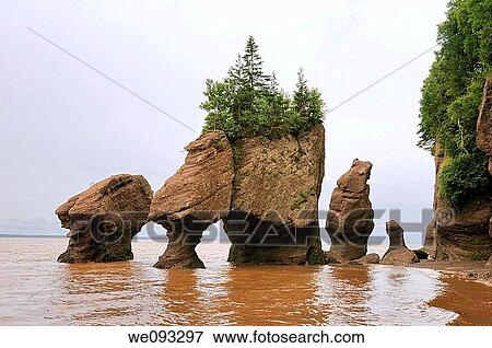 Lovers Arch and Bear Rock sea stacks with incoming tide at Hopewell Rocks Bay of Fundy View Large Photo Image Stock Photo - Lovers Arch and Bear Rock sea stacks with incoming tide at Hopewell Rocks Bay of Fundy. Fotosearch
