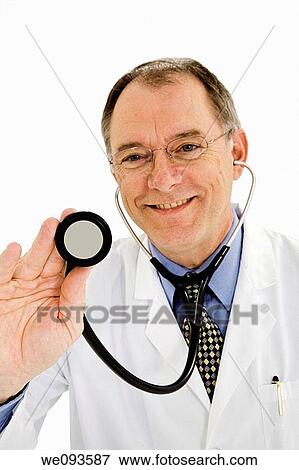 Male doctor holding stethoscope, close-up, portrait View Large Photo Image Stock Photo - Male doctor holding stethoscope, close-up, portrait. Fotosearch