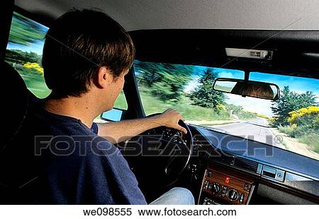 Man inside a speeding car driving on a country side road View Large Photo Image Stock Photography - Man inside a speeding car driving on a country side road. Fotosearch