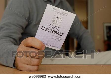 Stock Image - Man s hand showing his French voting card. Fotosearch