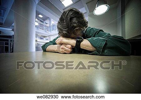 Man sitting at a table. View Large Photo Image Stock Image - Man sitting at a table.. Fotosearch
