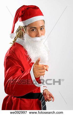 Man with dreadlocks dressed as Santa Claus pointing his finger View Large Photo Image Stock Photo - Man with dreadlocks dressed as Santa Claus pointing his finger. Fotosearch