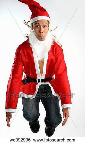 Man with dreadlocks dressed as Santa Claus jumping in the air View Large Photo Image Stock Photograph - Man with dreadlocks dressed as Santa Claus jumping in the air. Fotosearch