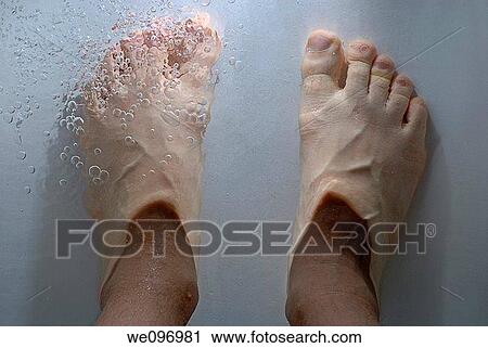 Stock Image - Man's feet in the bathtub. Fotosearch