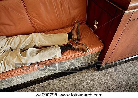 Man's resting in a booth in an office building lobby View Large Photo Image Stock Photo - Man's resting in a booth in an office building lobby. Fotosearch