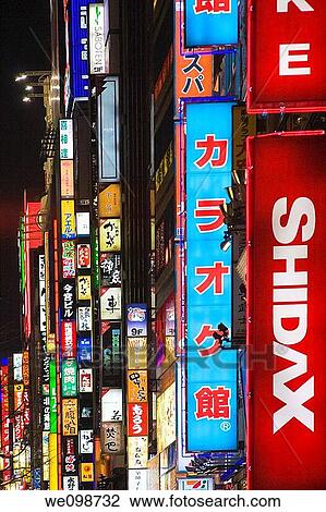 Many vertical Japanese signs glowing at night View Large Photo Image Stock Image - Many vertical Japanese signs glowing at night. Fotosearch