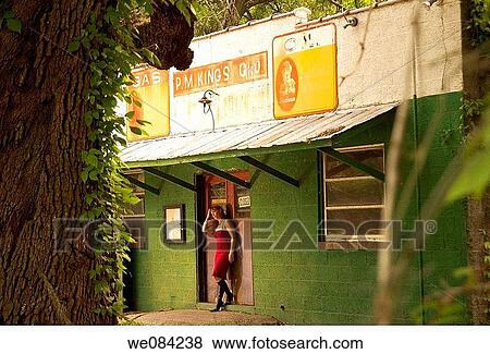 MODERN WOMAN OUTSIDE OLD STORE View Large Photo Image Stock Photo - MODERN WOMAN OUTSIDE OLD STORE. Fotosearch