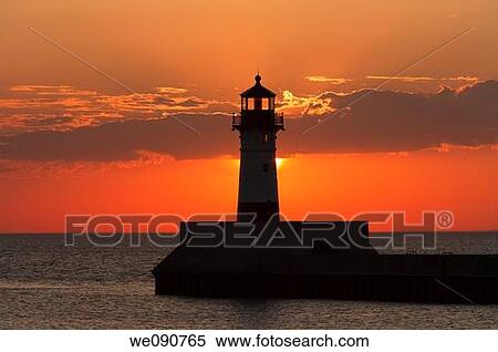 Stock Photography - Morning silhouette of a lighthouse on Lake Superior in Duluth, Minnesota. Fotosearch