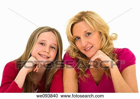 Mother and daughter laying on a white background together in casual clothing View Large Photo Image Stock Image - Mother and daughter laying on a white background together in casual clothing. Fotosearch