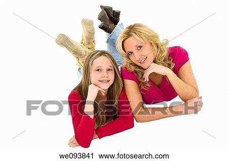 Mother and daughter laying on a white background together in casual clothing View Large Photo Image Stock Image - Mother and daughter laying on a white background together in casual clothing. Fotosearch