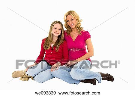 Mother and daughter seting on a white background together in casual clothing View Large Photo Image Stock Photo - Mother and daughter seting on a white background together in casual clothing. Fotosearch