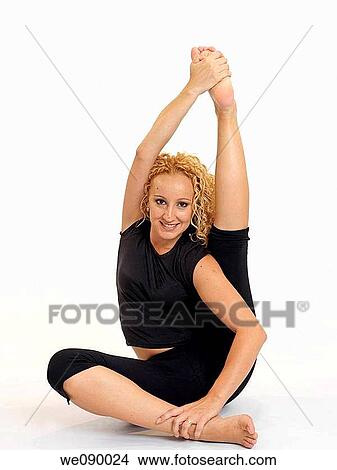 Mujer joven realizando estiramientos View Large Photo Image Picture - Mujer joven realizando estiramientos. Fotosearch