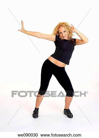 Mujer joven realizando movimientos de baile View Large Photo Image Stock Image - Mujer joven realizando movimientos de baile. Fotosearch