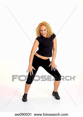 Mujer joven realizando movimientos de baile View Large Photo Image Stock Image - Mujer joven realizando movimientos de baile. Fotosearch