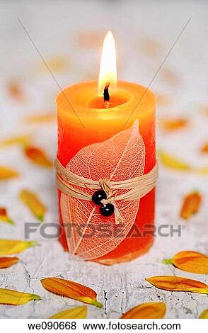 Stock Photo - Orange candle. Fotosearch