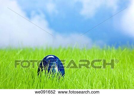 Osterei im Gras mit Himmel / Easter egg on the grassland and the heaven in the background View Large Photo Image Stock Image - Osterei im Gras mit Himmel / Easter egg on the grassland and the heaven in the background. Fotosearch