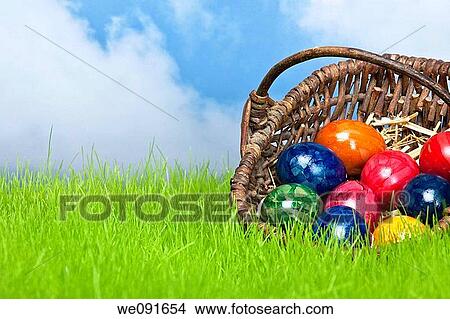 Ostereier im Korb mit Himmel / Easter eggs in a basket on the grassland and the heaven in the background View Large Photo Image Picture - Ostereier im Korb mit Himmel / Easter eggs in a basket on the grassland and the heaven in the background. Fotosearch