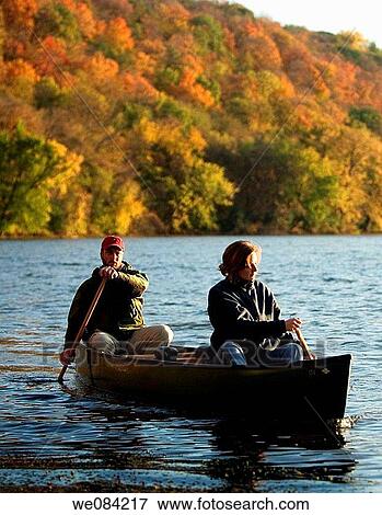 PADDLING CANOE ON A FALL LAKE IN MINNESOTA View Large Photo Image Stock Photo - PADDLING CANOE ON A FALL LAKE IN MINNESOTA. Fotosearch