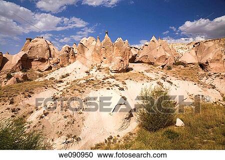 Stock Image - Pedestal and cone shaped eroded rock formations hardened volcanic ash in the Camel valley, Cappadocia region, Turkey. Fotosearch