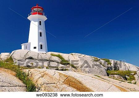 Peggys Cove lighthouse on top of smooth granite rocks against a blue sky Nova Scotia View Large Photo Image Stock Photo - Peggys Cove lighthouse on top of smooth granite rocks against a blue sky Nova Scotia. Fotosearch