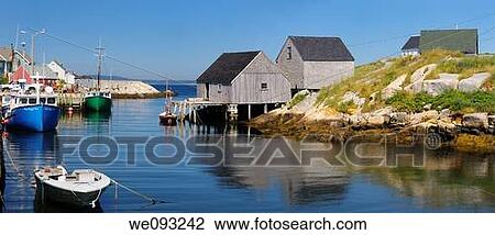 Stock Image - Peggys Cove off of St Margarets Bay Nova Scotia with fishing village houses and boats. Fotosearch