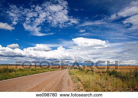 Picturesque scene of a farm along a dirt road in a vast rural landscape with cumulus cloud formations in southwest Colorado View Large Photo Image Stock Image - Picturesque scene of a farm along a dirt road in a vast rural landscape with cumulus cloud formations in southwest Colorado. Fotosearch