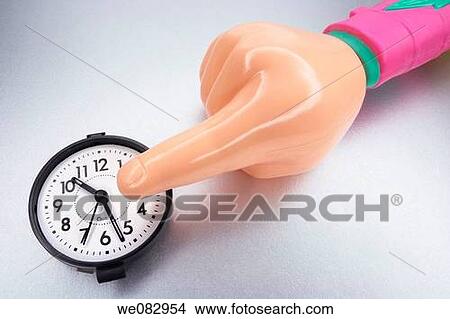 Picture - Plastic Hand and Clock. Fotosearch