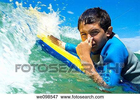 Stock Photo - Playing with the waves. Fotosearch