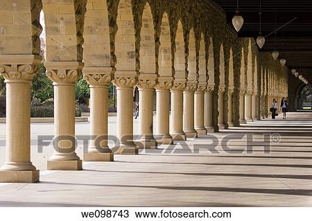 Portico in the Main Quad of Stanford University, with shadows cast from the columns of the sandstone arches and people walking in the distance Stanford, California View Large Photo Image Stock Image - Portico in the Main Quad of Stanford University, with shadows cast from the columns of the sandstone arches and people walking in the distance Stanford, California. Fotosearch