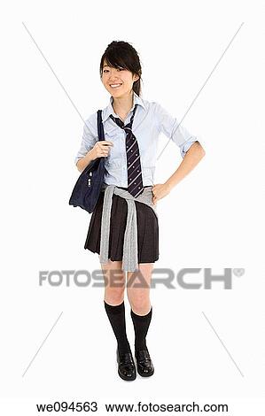 Portrait of a female Asian teenager dressed in the traditional Japanese schoolgirl clothing Uniforms are worn by most of the female school children in Japan She is standing on a white background and smiling View Large Photo Image Stock Image - Portrait of a female Asian teenager dressed in the traditional Japanese schoolgirl clothing Uniforms are worn by most of the female school children in Japan She is standing on a white background and smiling. Fotosearch