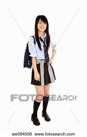 Portrait of a female Asian teenager dressed in the traditional Japanese schoolgirl clothing Uniforms are worn by most of the female school children in Japan She is standing on a white background and smiling View Large Photo Image Stock Photograph - Portrait of a female Asian teenager dressed in the traditional Japanese schoolgirl clothing Uniforms are worn by most of the female school children in Japan She is standing on a white background and smiling. Fotosearch