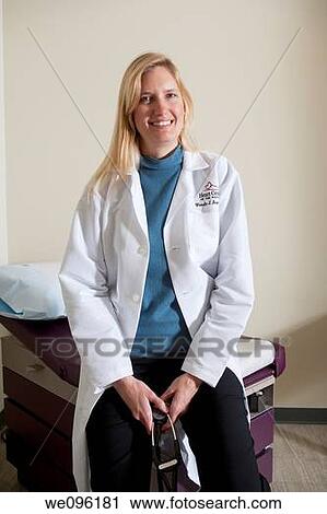Portrait of a female doctor holding a stethoscope in an medical health exam room. View Large Photo Image Stock Image - Portrait of a female doctor holding a stethoscope in an medical health exam room.. Fotosearch