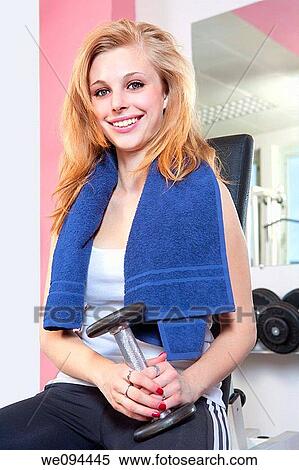portrait of a young woman holding dumbbell in modern gym View Large Photo Image Stock Photography - portrait of a young woman holding dumbbell in modern gym. Fotosearch