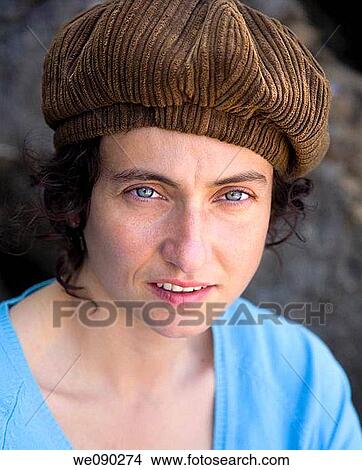 Portrait of a young woman with blue eyes and a corduroy cap View Large Photo Image Picture - Portrait of a young woman with blue eyes and a corduroy cap. Fotosearch