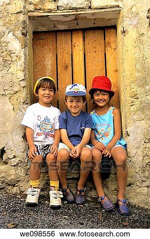 Portrait of three children smiling looking at camera View Large Photo Image Stock Photograph - Portrait of three children smiling looking at camera. Fotosearch