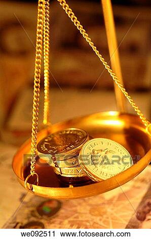 Pound coins in pan of weighing balance View Large Photo Image Stock Image - Pound coins in pan of weighing balance. Fotosearch