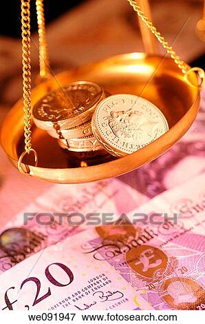 Pound coins in pan of weighing balance View Large Photo Image Stock Photo - Pound coins in pan of weighing balance. Fotosearch