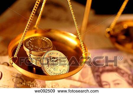 Pound coins in pan of weighing balance View Large Photo Image Stock Photo - Pound coins in pan of weighing balance. Fotosearch