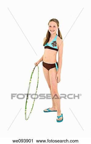 Preteen caucasian girl standing on a white background in a swimsuit holding a hula hoop View Large Photo Image Stock Image - Preteen caucasian girl standing on a white background in a swimsuit holding a hula hoop. Fotosearch