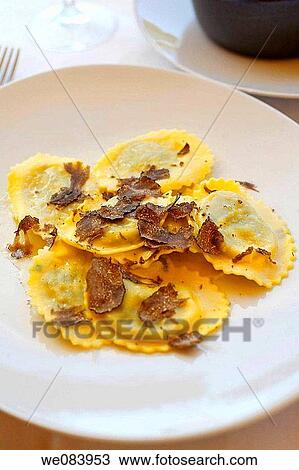 Stock Image - Ravioli with black truffles, Tuscan restaurant, Italy. Fotosearch