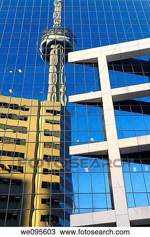 Stock Image - Reflection of the CN tower and highrise building in the glass windows of the CBC building in Toronto Canada. Fotosearch