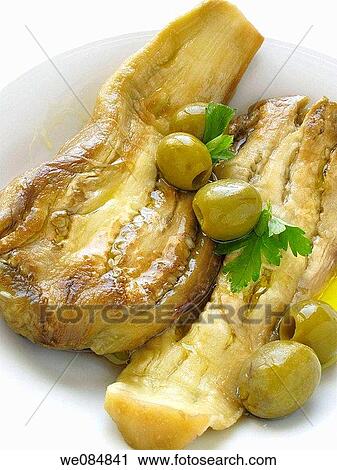 Stock Image - Roasted aubergine and olives. Fotosearch