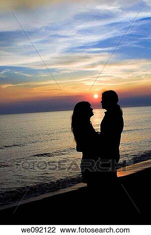 Romantic couple at sunset View Large Photo Image Stock Image - Romantic couple at sunset. Fotosearch
