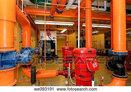 Row of furnaces and hot water pipes in the boiler room of a highrise office building View Large Photo Image Stock Image - Row of furnaces and hot water pipes in the boiler room of a highrise office building. Fotosearch