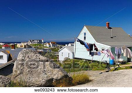 Rural fishing village houses with laundry and the lighthouse at Peggys Cove Nova Scotia View Large Photo Image Stock Image - Rural fishing village houses with laundry and the lighthouse at Peggys Cove Nova Scotia. Fotosearch